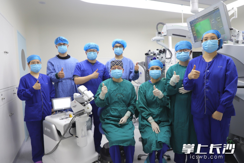 陈忠平教授团队与手术机器人合影。 通讯员供图 陈忠平教授团队与手术机器人合影。 通讯员供图